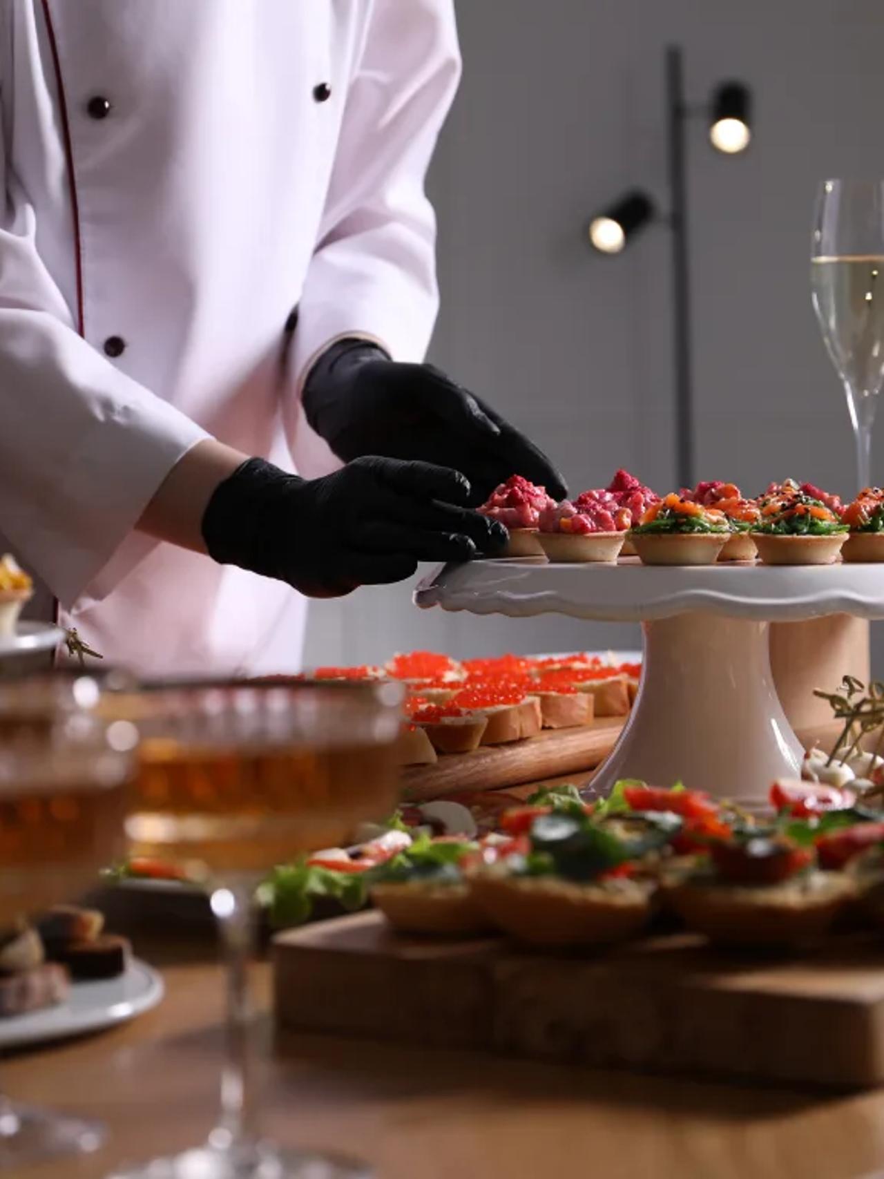 Catering setup with gourmet appetizers and champagne glasses.
