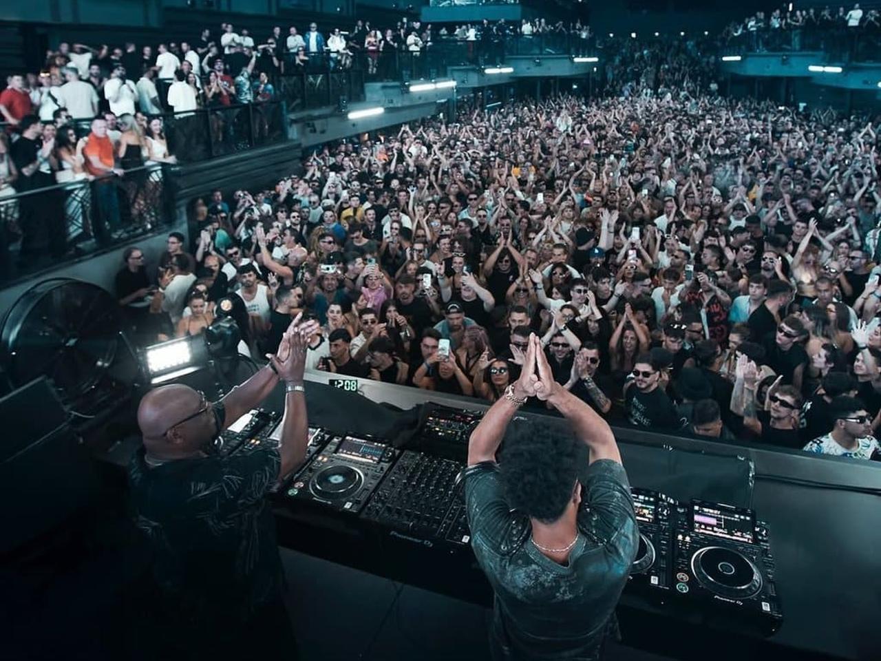 Crowd enjoying a concert with DJs at a club