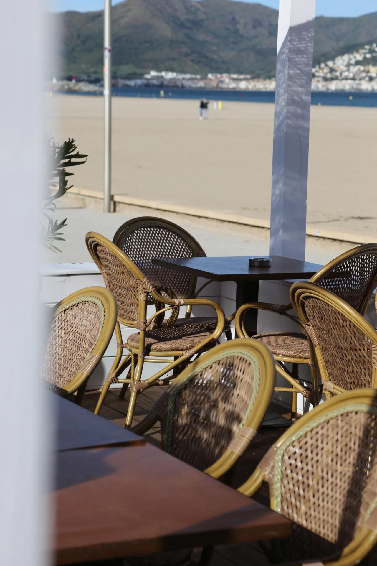 Outdoor dining area with wicker chairs and tables