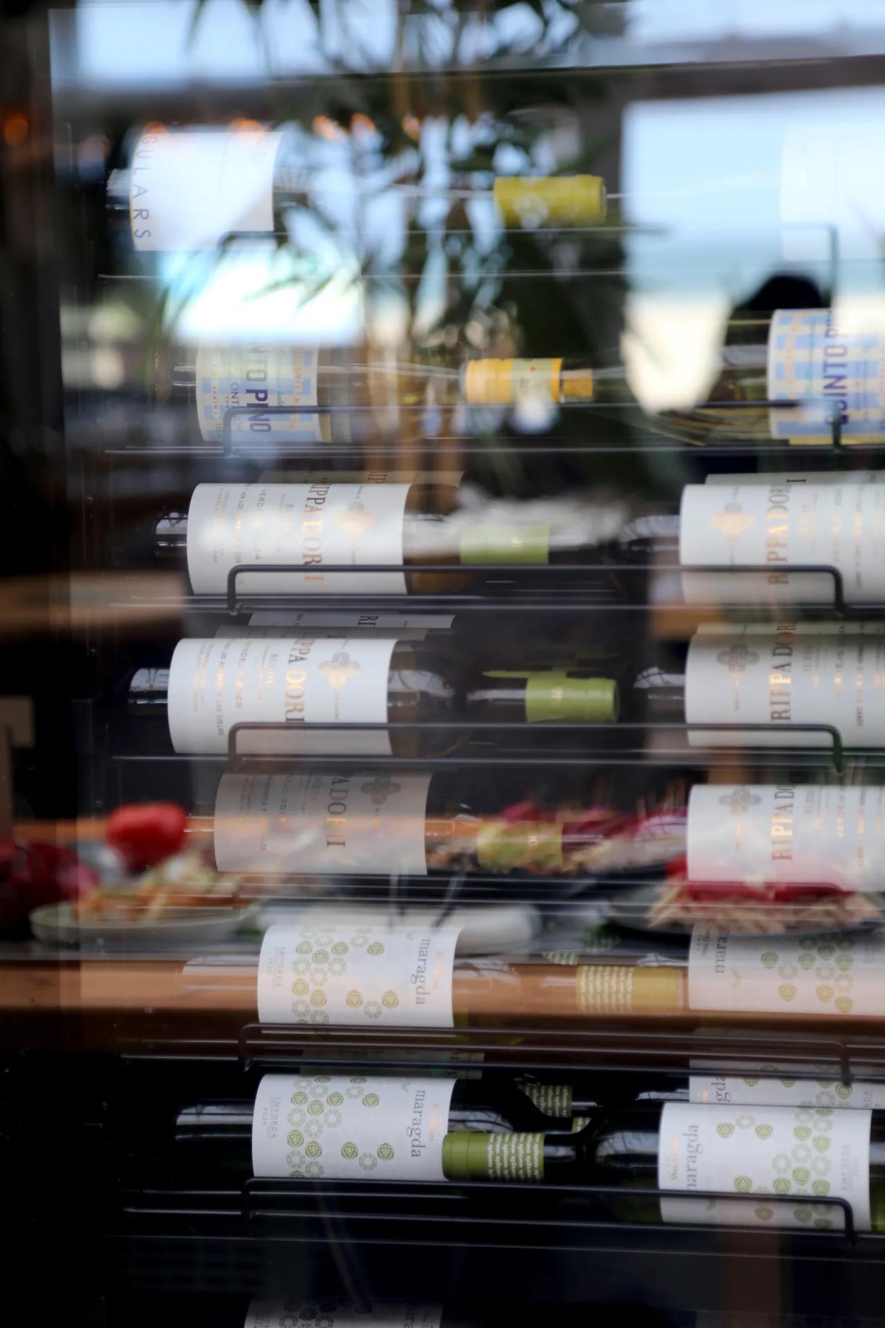 Wine bottles displayed in a restaurant wine rack.