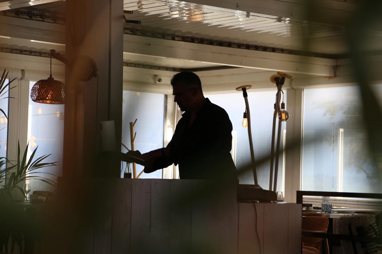 Silhouette of a person working at a restaurant counter