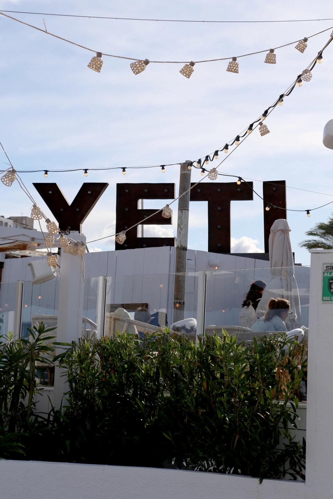 Outdoor view of YETI restaurant with decorative lights.
