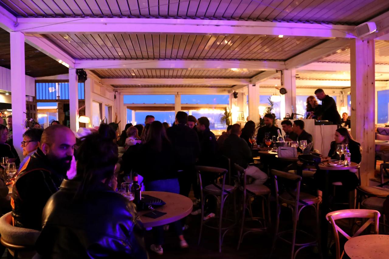 Interior view of a lively restaurant with guests dining.