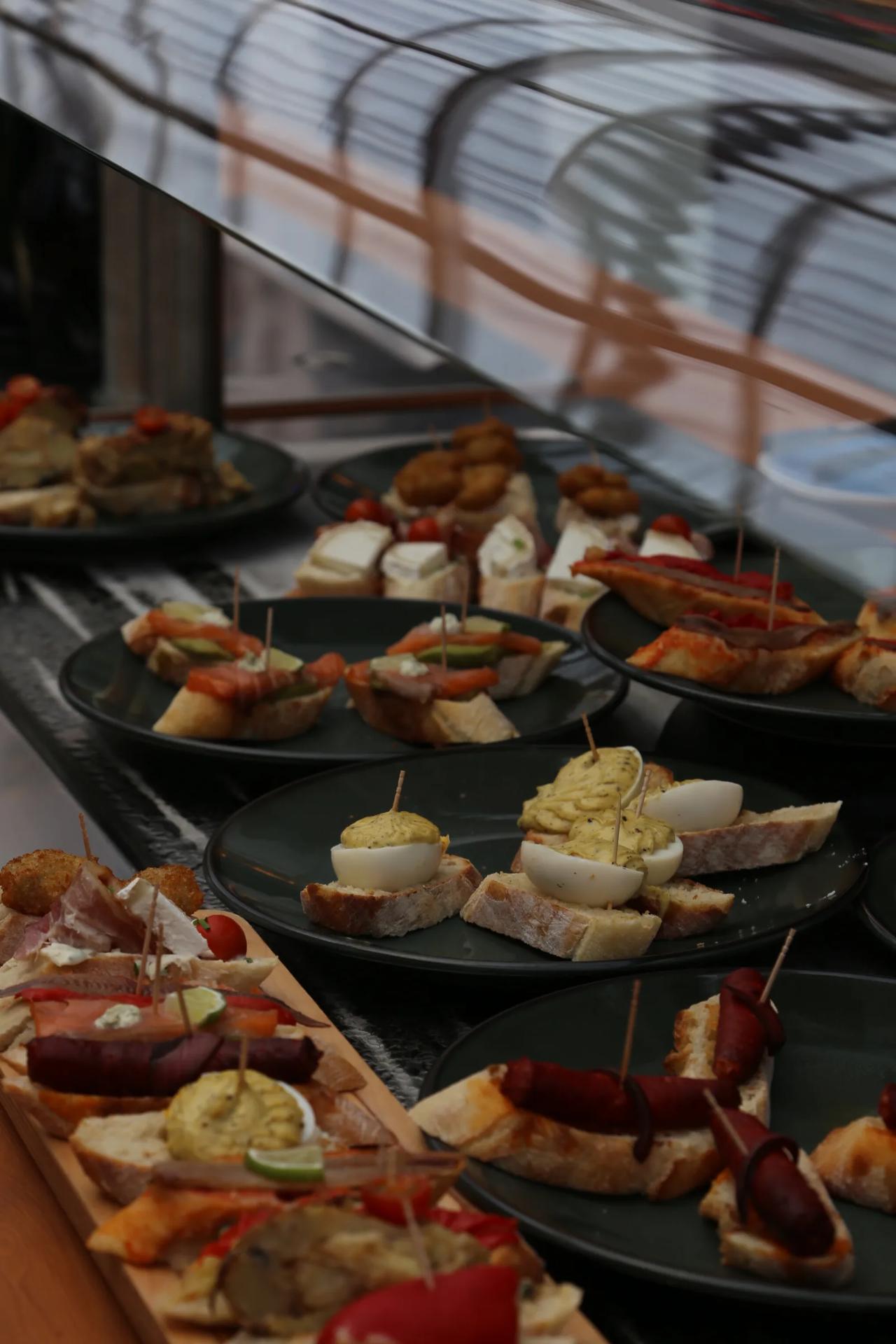 Variety of tapas served on black plates