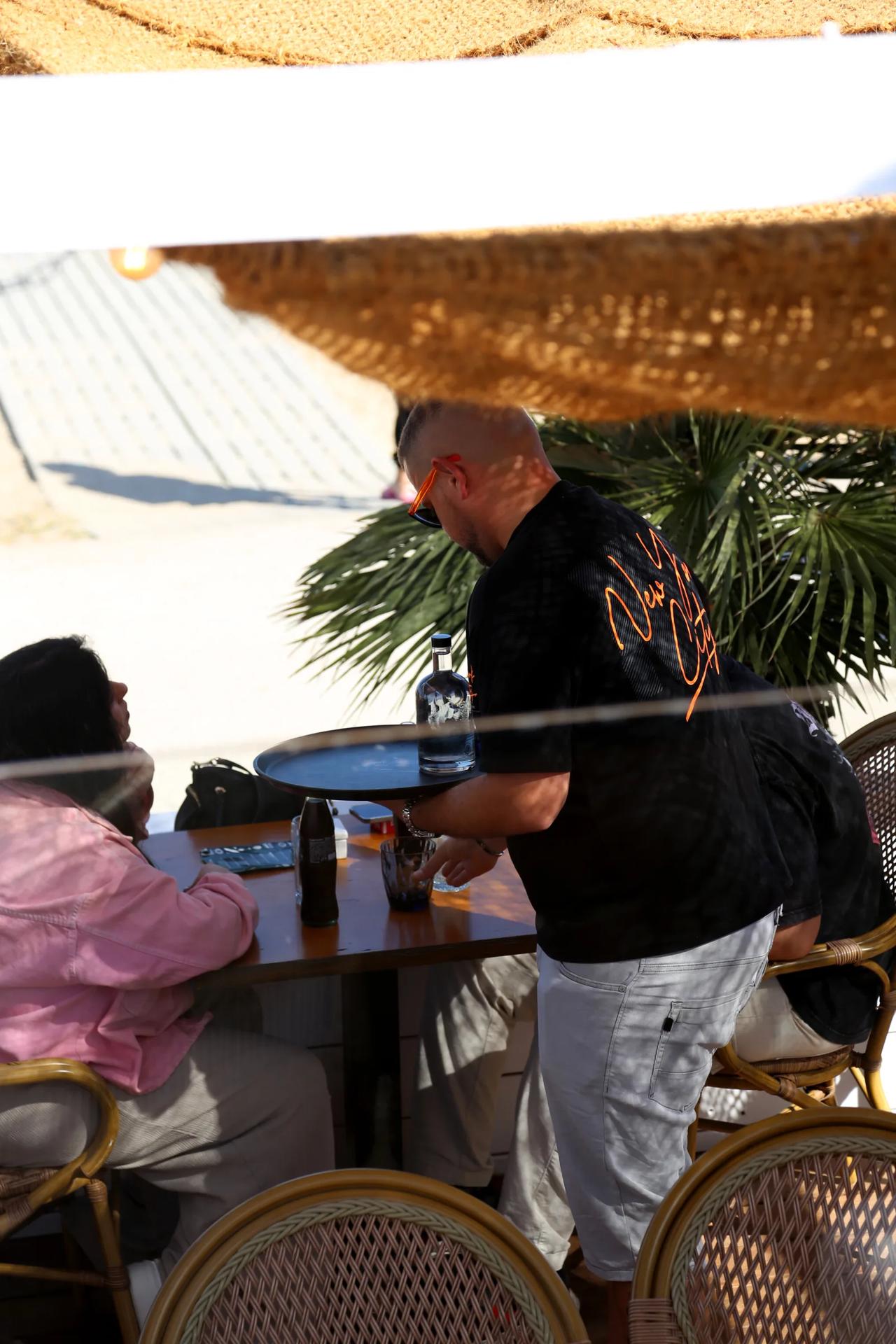 Server attending to customers at a restaurant table