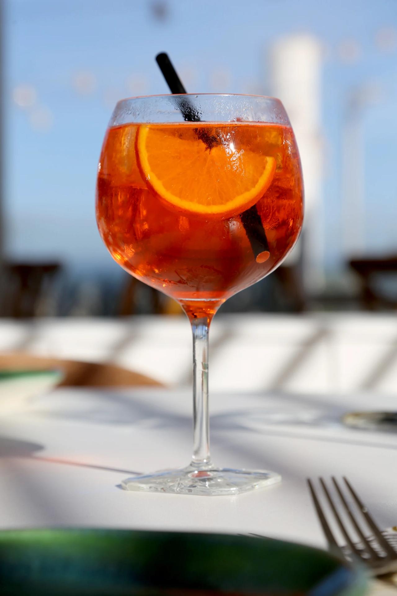 A refreshing cocktail with orange slice and straw