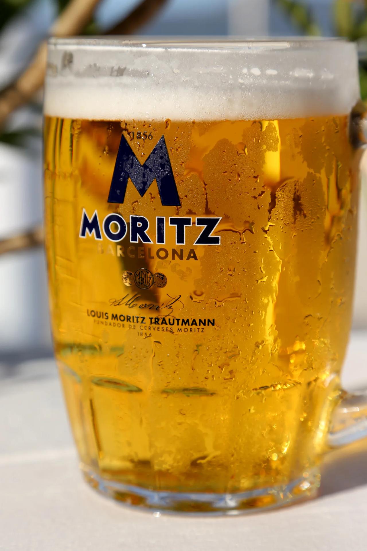 Close-up of a cold beer in a glass mug with condensation.