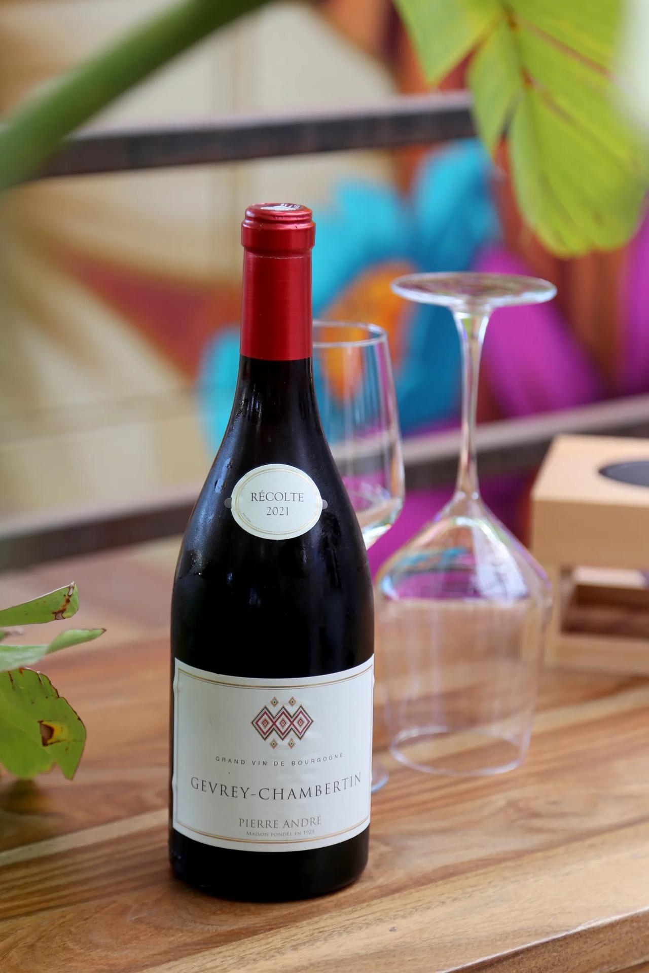 Bottle of Gevrey-Chambertin wine on a wooden table