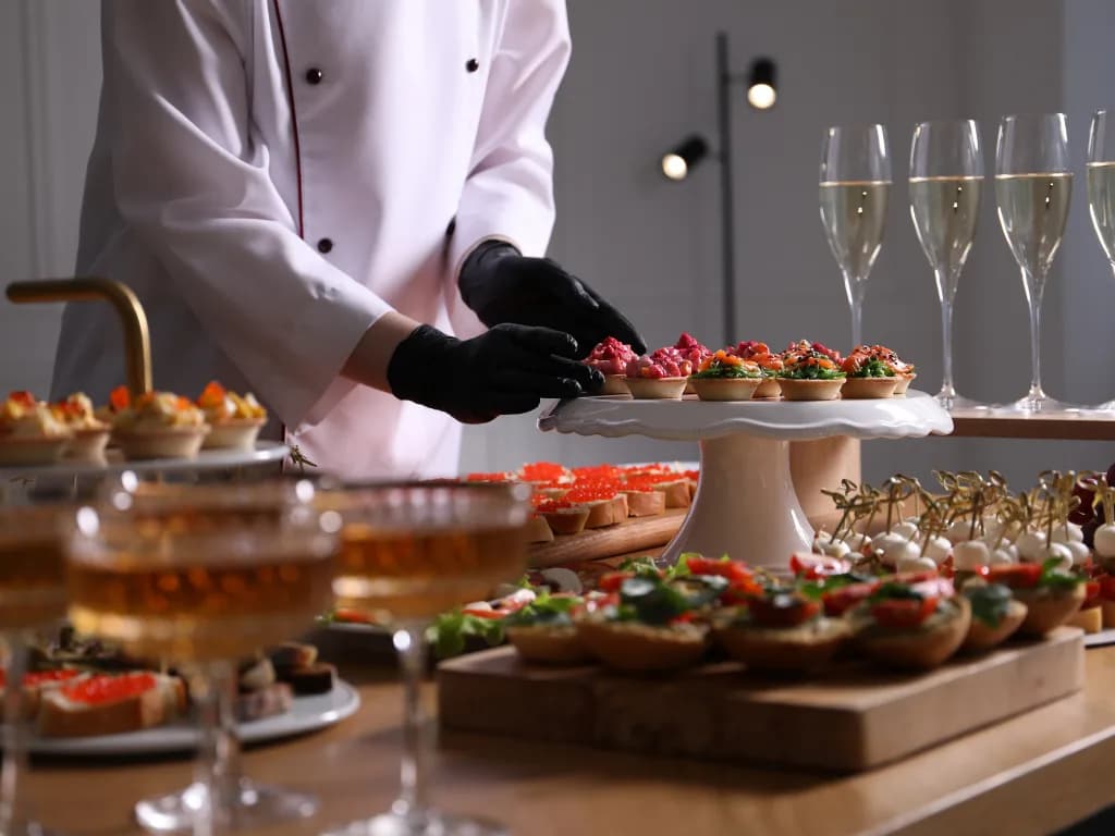 Catering setup with gourmet appetizers and champagne glasses.
