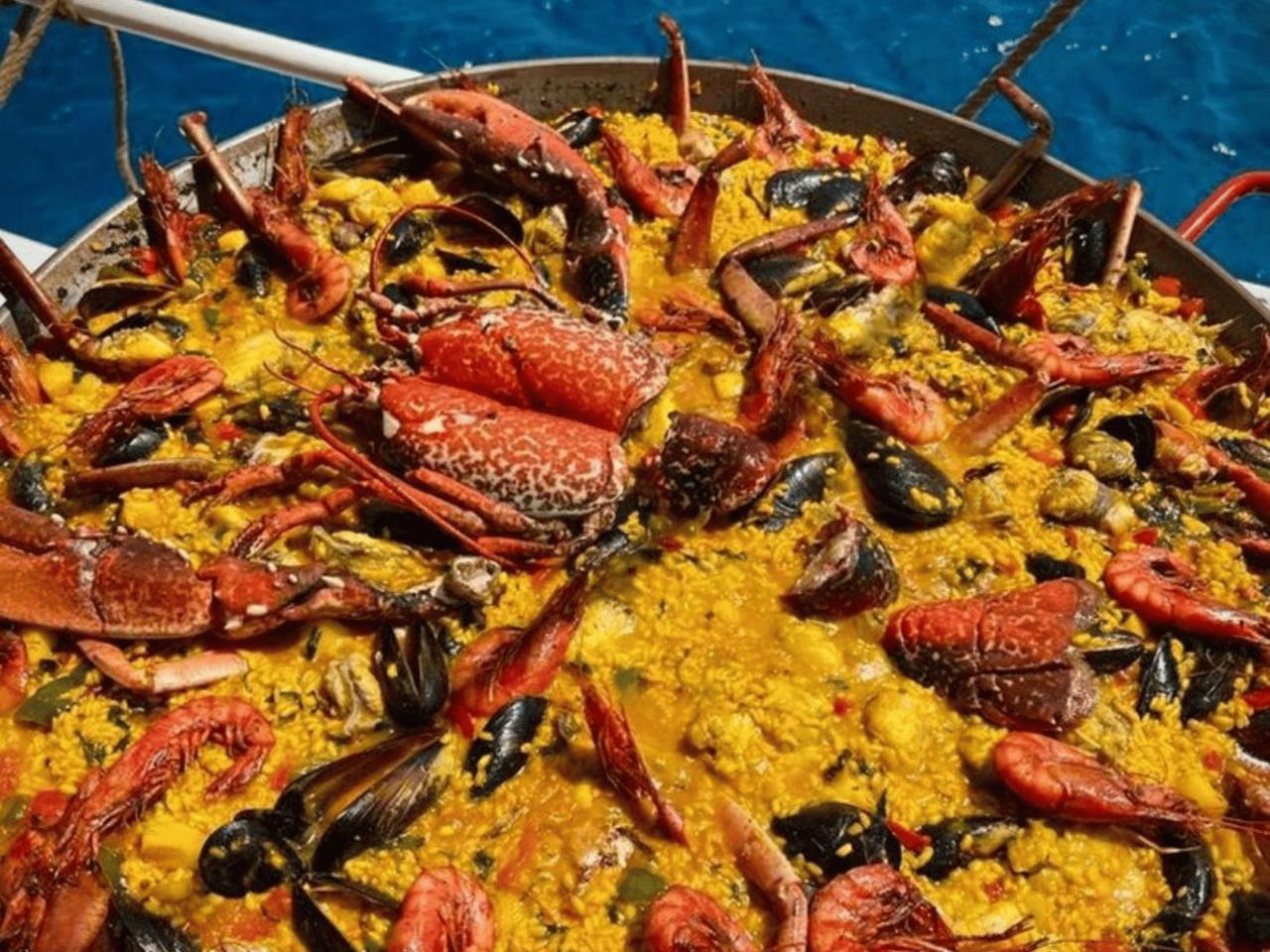 A vibrant seafood paella filled with various shellfish and saffron rice.