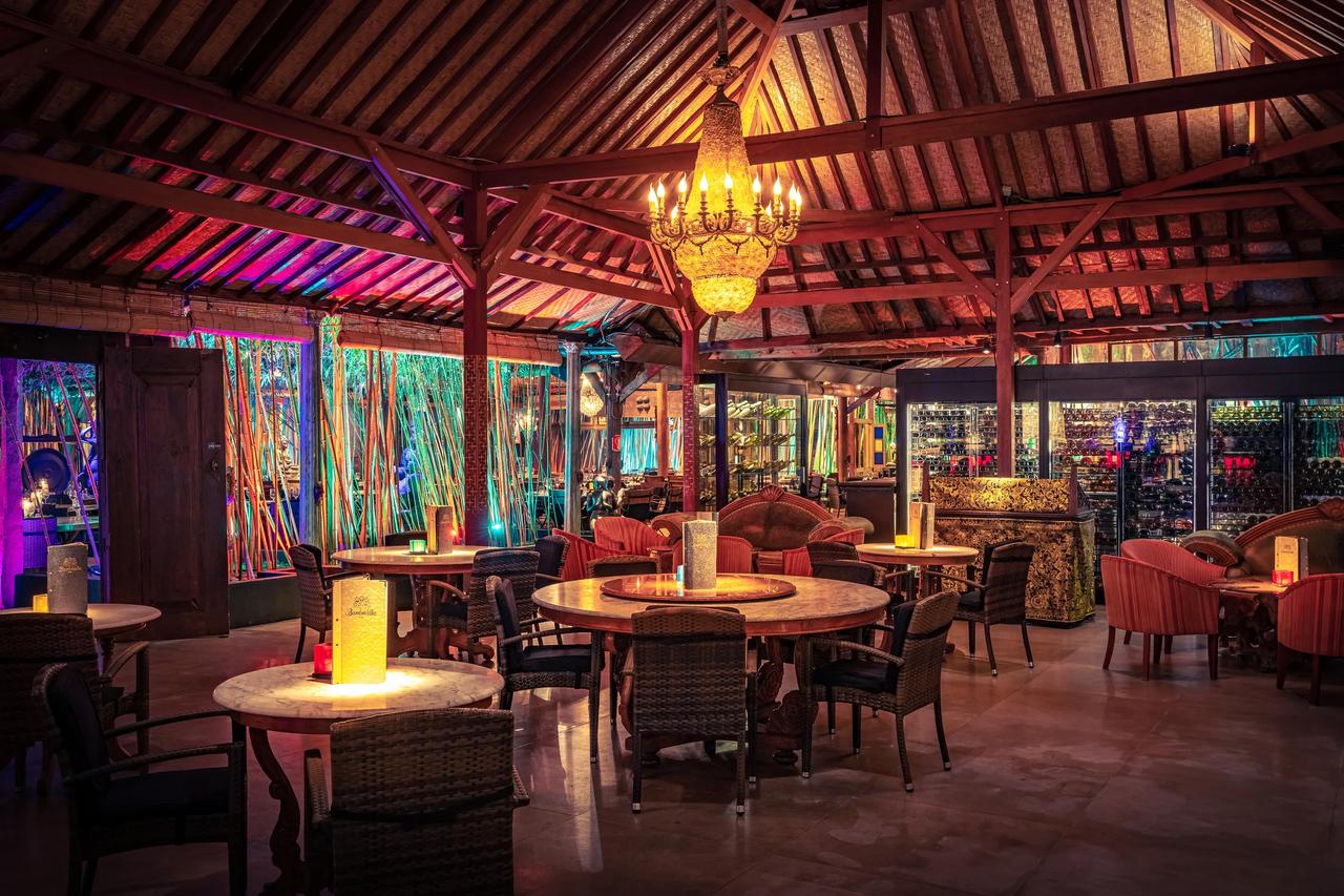 Interior of a vibrant restaurant with colorful lighting and elegant decor.