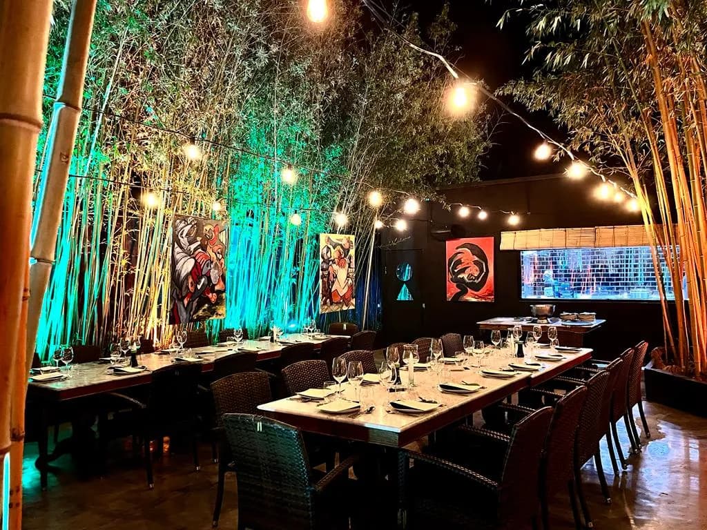 Outdoor dining area with bamboo and artistic decor