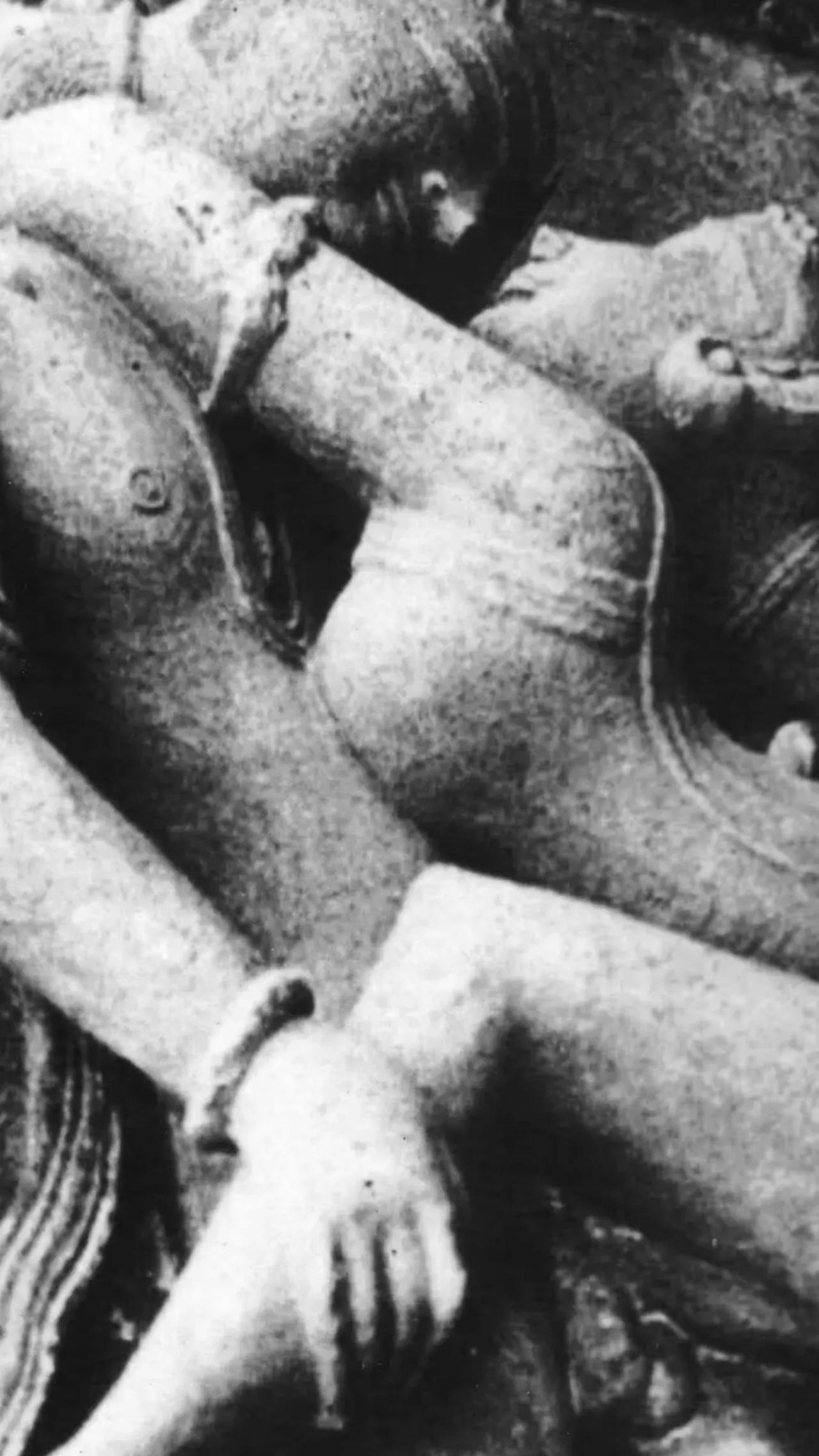 Close-up of a stone sculpture depicting intertwined figures.